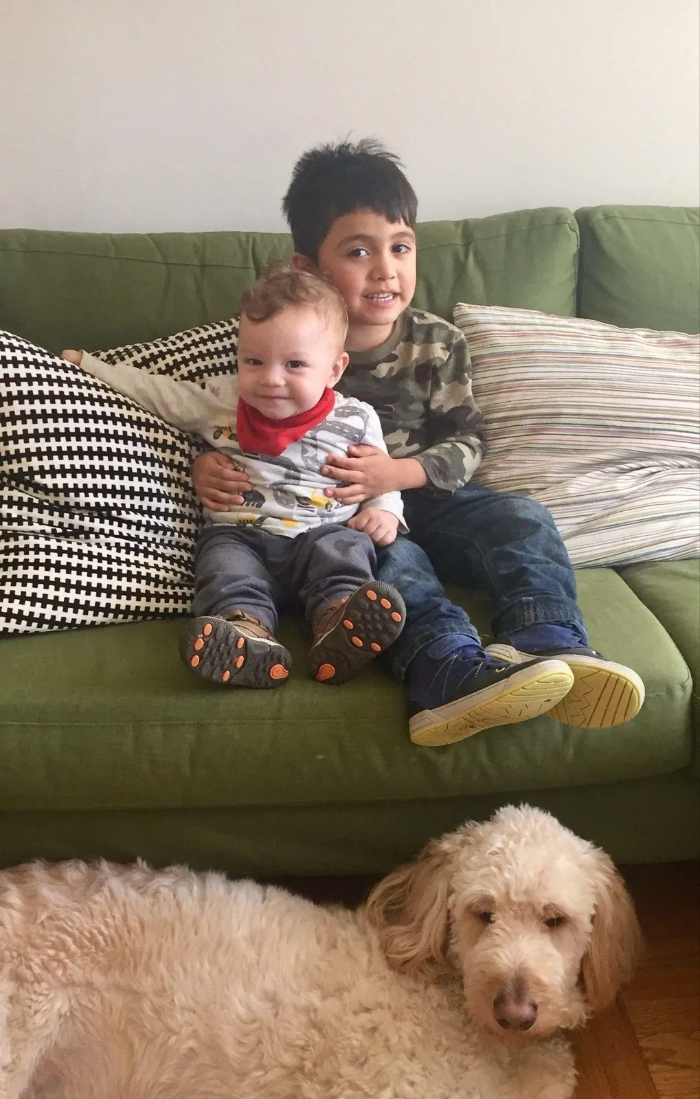 The boys on the couch with Charlie resting at their feet